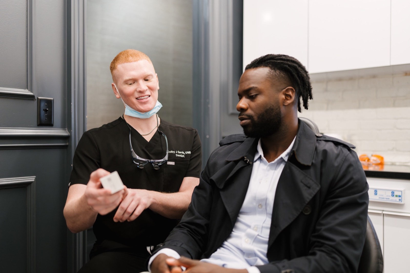 Dr. Colby showing a patient something during a consultation