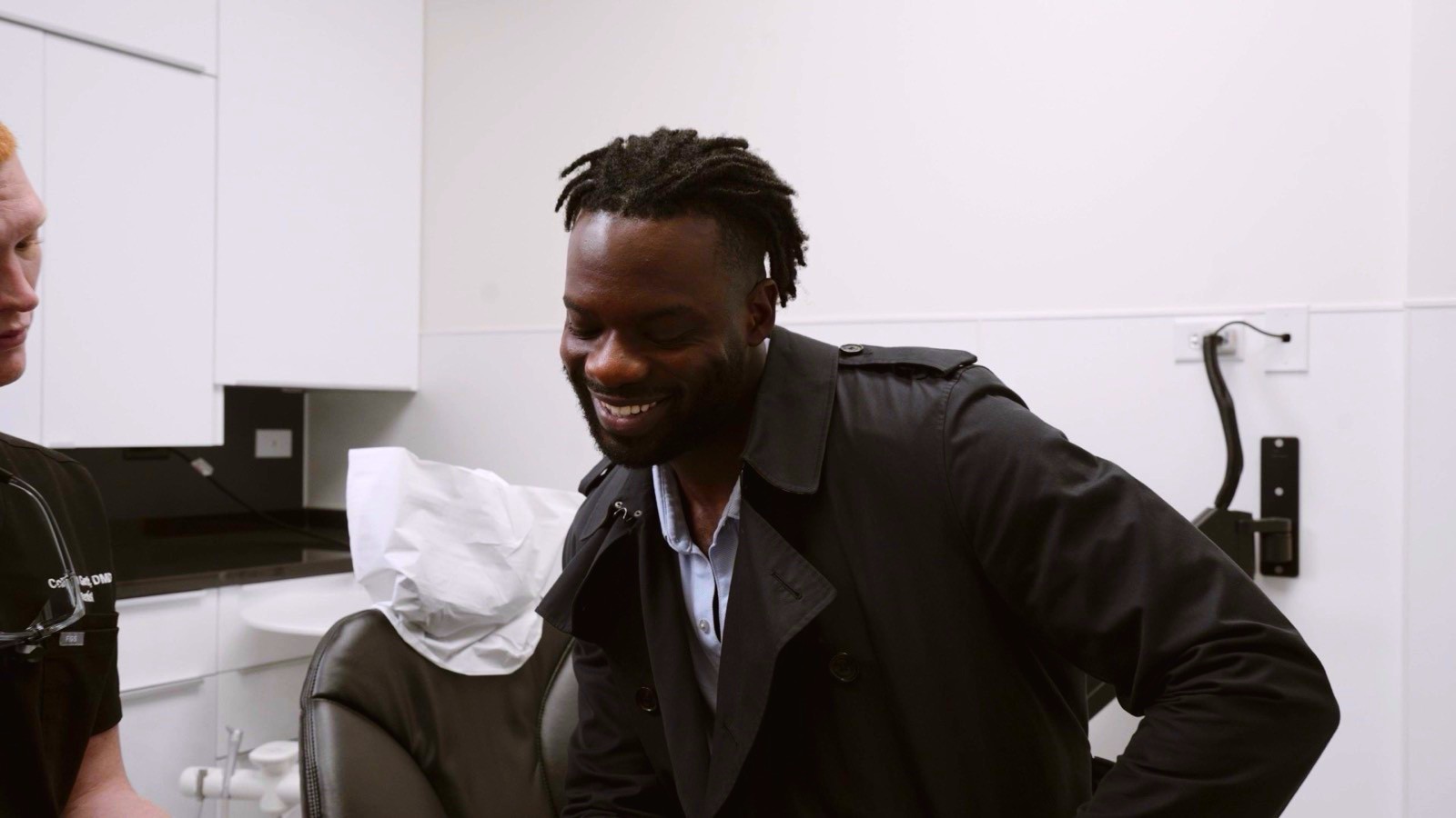 A patient smiling during a consultation