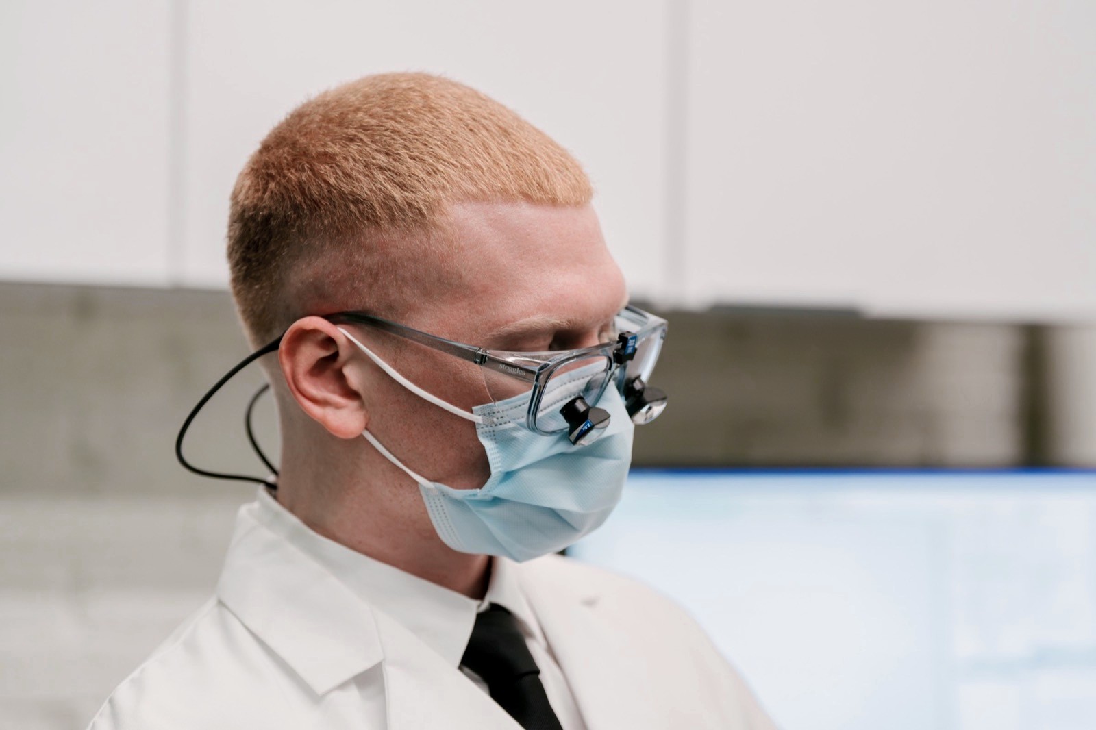 Dr. Colby in his loupes, reviewing images at the monitor