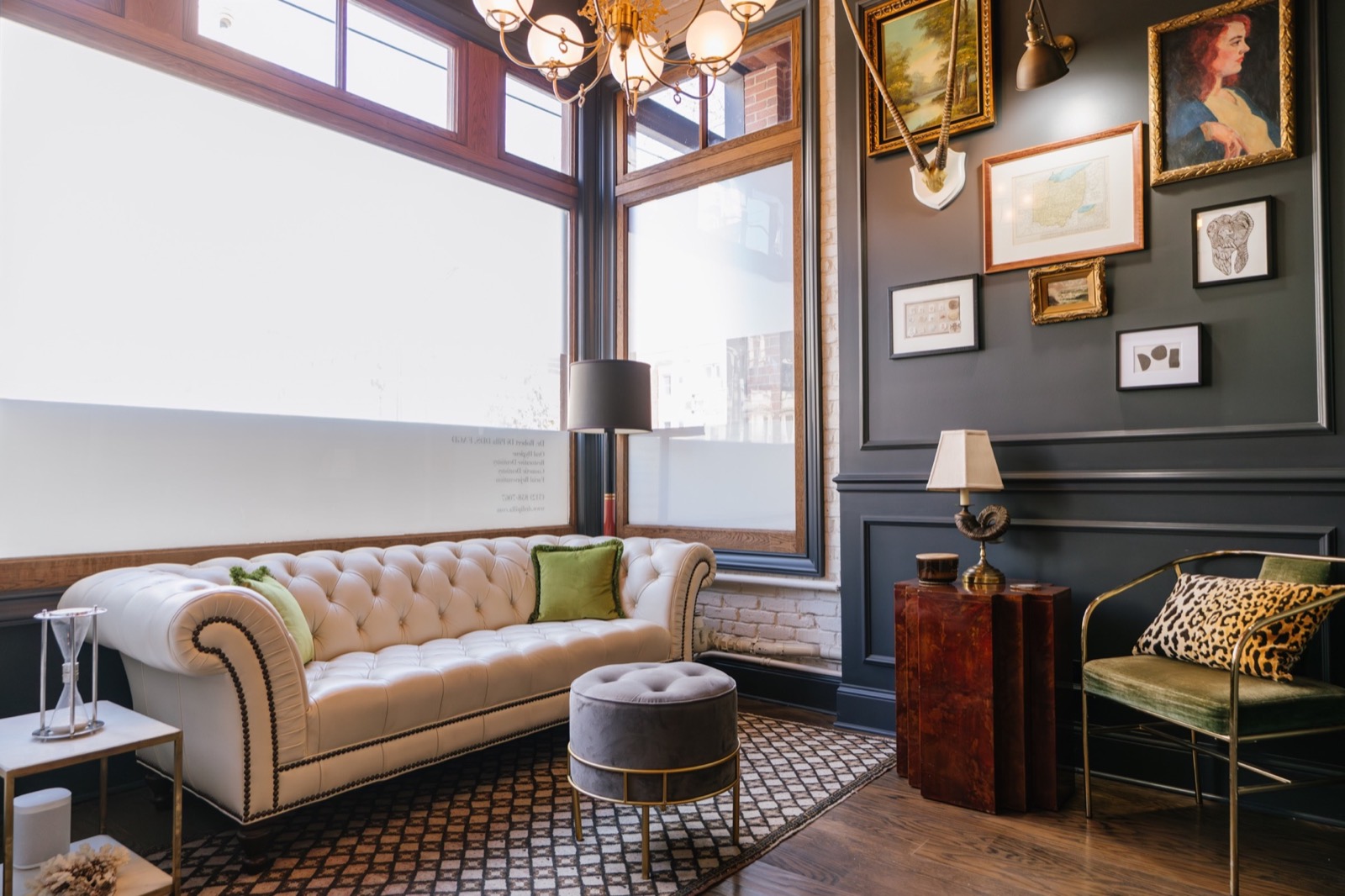 The salon at Pearl, a velvet sofa under the chandeliers
