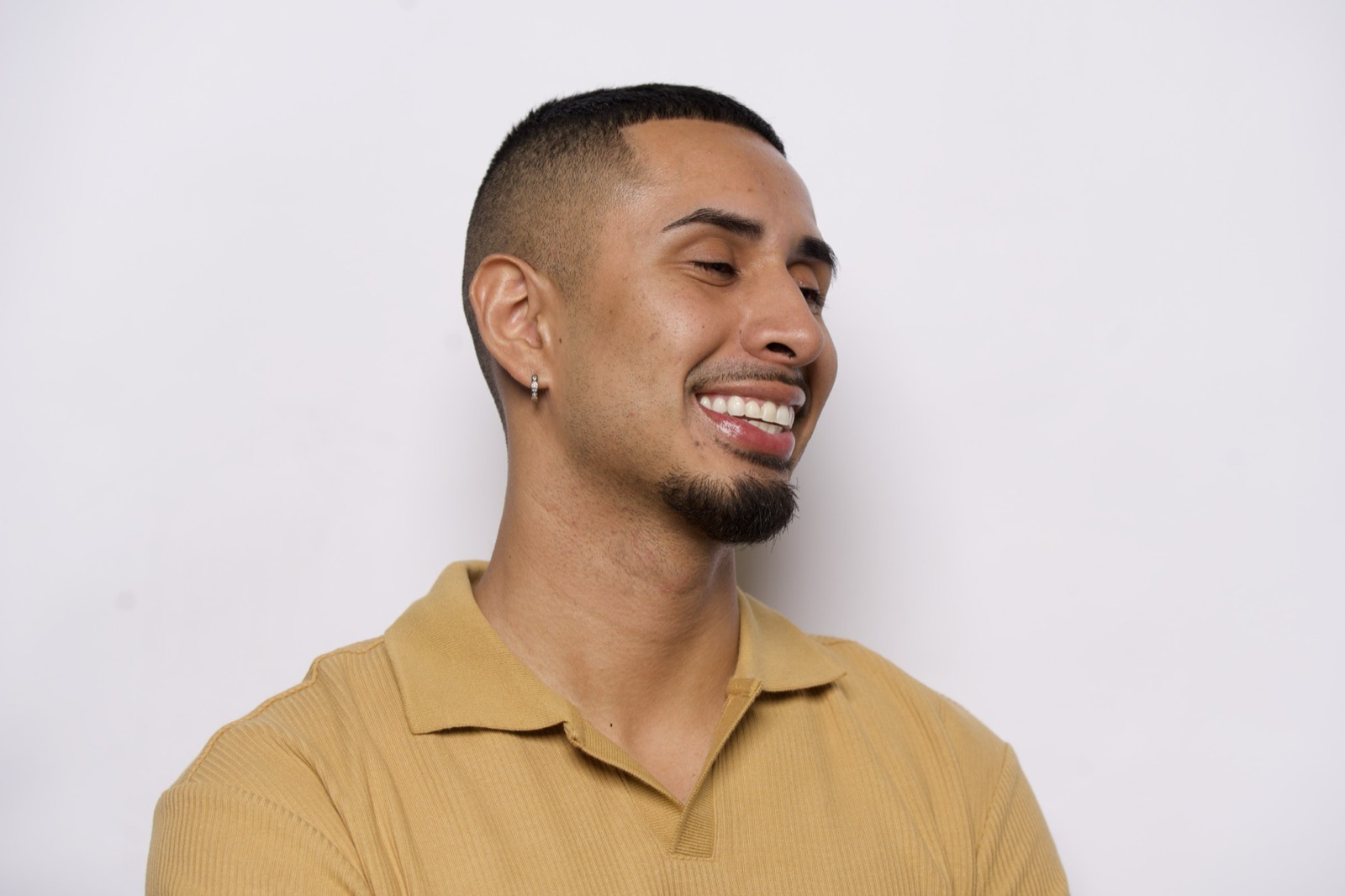 A man in a yellow polo, smiling