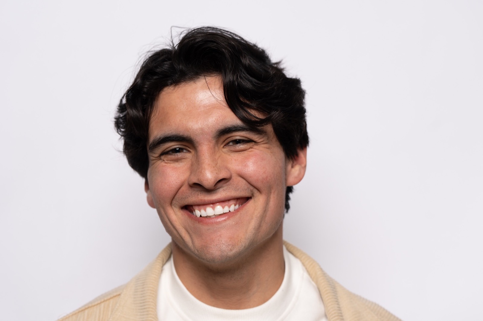 A man with a wide, natural smile