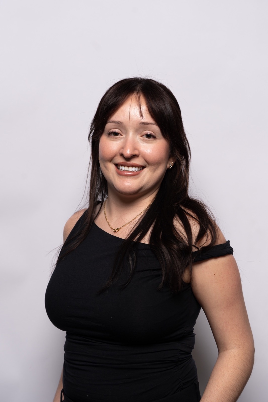 A woman smiling in a studio portrait